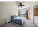 Bright main bedroom with balcony access and beautiful tropical views at 1236 Rio De Janeiro Ave # 406, Punta Gorda, FL 33983