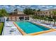 A refreshing community pool area featuring inviting lounge chairs, a charming cabana, and well maintained landscaping at 1236 Rio De Janeiro Ave # 406, Punta Gorda, FL 33983