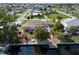 Aerial view of home with a screened pool, backyard dock and boat on a canal at 125 Small Se St, Port Charlotte, FL 33952