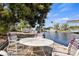Backyard area with mature trees, a patio and a view of the water at 125 Small Se St, Port Charlotte, FL 33952