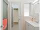 Clean bathroom featuring tiled walls, glass shower door, and an adjacent room through the doorway at 125 Small Se St, Port Charlotte, FL 33952
