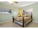 Bright bedroom featuring terrazzo floors and a traditional wrought iron bed frame with matching furnishings at 125 Small Se St, Port Charlotte, FL 33952