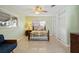 Charming bedroom featuring a decorative metal bed frame, ceiling fan, and built-in closet at 125 Small Se St, Port Charlotte, FL 33952