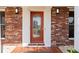 Charming brick home with a welcoming front door that features decorative glass and sidelights at 125 Small Se St, Port Charlotte, FL 33952