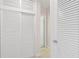 Bright hallway with white louvered doors and a peek into another room at 125 Small Se St, Port Charlotte, FL 33952