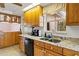 Functional kitchen with updated countertops, ample cabinet space, and stainless steel dishwasher and sink at 125 Small Se St, Port Charlotte, FL 33952