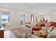 Bright living room featuring neutral walls, Terrazzo floors, comfortable seating, and dining area at 125 Small Se St, Port Charlotte, FL 33952