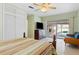 Main bedroom featuring sliding glass doors to pool, terrazzo floors, and soft green paint at 125 Small Se St, Port Charlotte, FL 33952