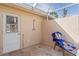 Outdoor shower with door to interior, beach chair, and tile flooring at 125 Small Se St, Port Charlotte, FL 33952