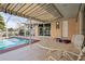 Covered patio with pool access and waterfront views, ideal for outdoor relaxation and entertainment at 125 Small Se St, Port Charlotte, FL 33952