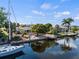 Picturesque waterfront home with a boat dock, lush landscaping, and serene water views at 125 Small Se St, Port Charlotte, FL 33952