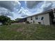 A backyard with a screened lanai, lush landscaping, and well-maintained lawn creates a relaxing outdoor retreat at 1318 San Mateo Dr, Punta Gorda, FL 33950