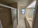 Bathroom featuring double sinks, a large mirror, a shower with glass doors, and bright lighting at 1318 San Mateo Dr, Punta Gorda, FL 33950