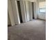 A carpeted bedroom with natural light, large closets, and neutral paint provides a cozy and functional space at 1318 San Mateo Dr, Punta Gorda, FL 33950