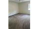 A spacious bedroom features neutral carpeting and ample natural light from a large window at 1318 San Mateo Dr, Punta Gorda, FL 33950