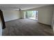 Spacious living room with a large picture window showcasing lush outdoor greenery and a ceiling fan at 1318 San Mateo Dr, Punta Gorda, FL 33950