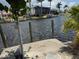 Waterfront property featuring a private dock, serene canal views, and tropical landscaping at 1318 San Mateo Dr, Punta Gorda, FL 33950