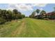 Long backyard view showcases lush greenery and privacy at 13256 Creekside Ln, Port Charlotte, FL 33953