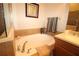 Bathroom featuring a soaking tub with tan-color tile surround, and a towel rack at 13256 Creekside Ln, Port Charlotte, FL 33953
