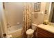 Full bathroom featuring a shower-tub combo with a shower curtain, toilet, and vanity at 13256 Creekside Ln, Port Charlotte, FL 33953