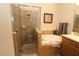Well-lit bathroom featuring a walk-in shower and a soaking tub with tan-color tile surround at 13256 Creekside Ln, Port Charlotte, FL 33953