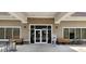 Exterior view of the clubhouse entrance with benches and clean landscaping at 13256 Creekside Ln, Port Charlotte, FL 33953