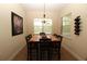 Dining room with a dark wood table, six chairs, and a decorative chandelier at 13256 Creekside Ln, Port Charlotte, FL 33953