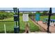 Fenced dog park with pet waste station, providing a safe and clean environment for furry friends to socialize at 13256 Creekside Ln, Port Charlotte, FL 33953