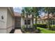 Beautiful single-story home showcasing lush landscaping, a tile roof, and a welcoming brick pathway to the front door at 13256 Creekside Ln, Port Charlotte, FL 33953
