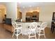 Modern kitchen featuring granite countertops, stainless steel appliances, and bar-style seating for casual dining at 13256 Creekside Ln, Port Charlotte, FL 33953