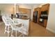 Open kitchen with stainless steel appliances, granite countertops, and breakfast bar seating at 13256 Creekside Ln, Port Charlotte, FL 33953