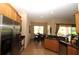 Bright kitchen with stainless steel appliances, granite counters, and view to the dining area at 13256 Creekside Ln, Port Charlotte, FL 33953