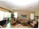 Cozy living room features comfortable seating, a coffee table, and a view of the outdoors at 13256 Creekside Ln, Port Charlotte, FL 33953