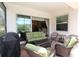 Inviting outdoor patio with comfortable seating and a grill, perfect for entertaining guests at 13256 Creekside Ln, Port Charlotte, FL 33953