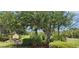 Community entrance featuring a 'Stillwater Trace' sign nestled among lush greenery, offering a serene setting at 13256 Creekside Ln, Port Charlotte, FL 33953