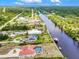 Panoramic aerial view of a waterfront community showcasing beautiful homes nestled along a scenic river at 13295 Eisenhower Dr, Port Charlotte, FL 33953
