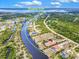 Aerial view showcasing the Myakka River flowing behind beautiful homes surrounded by lush greenery at 13295 Eisenhower Dr, Port Charlotte, FL 33953