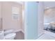 Modern bathroom featuring frosted sliding glass door, toilet and bidet and freestanding tub at 13295 Eisenhower Dr, Port Charlotte, FL 33953