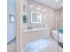 This bathroom has a modern floating vanity with under cabinet lights, and a large, bright, illuminated mirror at 13295 Eisenhower Dr, Port Charlotte, FL 33953