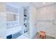 Modern bathroom with a sleek vanity, open shelving, and a spacious walk-in shower featuring beautiful tile work at 13295 Eisenhower Dr, Port Charlotte, FL 33953