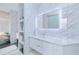 Bright, modern bathroom featuring floating vanity, sleek countertop, under cabinet lighting and open storage shelves at 13295 Eisenhower Dr, Port Charlotte, FL 33953