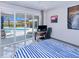 Cozy bedroom with sliding glass doors leading to the pool area and a dedicated workspace at 13295 Eisenhower Dr, Port Charlotte, FL 33953