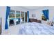 Bright bedroom featuring sliding glass doors to the pool area and a comfortable, patterned bedspread at 13295 Eisenhower Dr, Port Charlotte, FL 33953