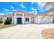 Beautiful white single Gathering home with a red tile roof and attached two car garage at 13295 Eisenhower Dr, Port Charlotte, FL 33953