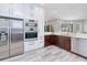 Kitchen with stainless steel appliances, white cabinetry, wood cabinets, and view of pool at 13295 Eisenhower Dr, Port Charlotte, FL 33953