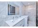 Modern laundry room with front loading washer and dryer, marble tile, and sleek vanity with modern fixtures at 13295 Eisenhower Dr, Port Charlotte, FL 33953
