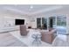 Relaxing living room with furniture, built-in shelving, and sliding glass doors to the pool at 13295 Eisenhower Dr, Port Charlotte, FL 33953