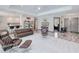 Bright living room features plush seating, recessed lighting, and smooth, modern flooring at 13295 Eisenhower Dr, Port Charlotte, FL 33953