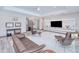 Stylish living room featuring modern furniture, a sleek entertainment center, and neutral color palette at 13295 Eisenhower Dr, Port Charlotte, FL 33953