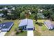 Aerial view of modern home with a well-manicured lawn and a lush green landscape at 14350 Marlin Ave, Port Charlotte, FL 33953